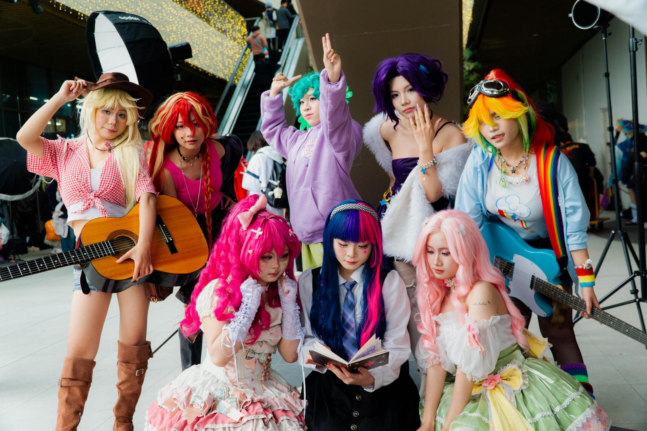 Vibrant group of cosplayers in anime costumes with musical instruments, showcasing diversity.